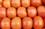 a pile of oranges sitting next to each other