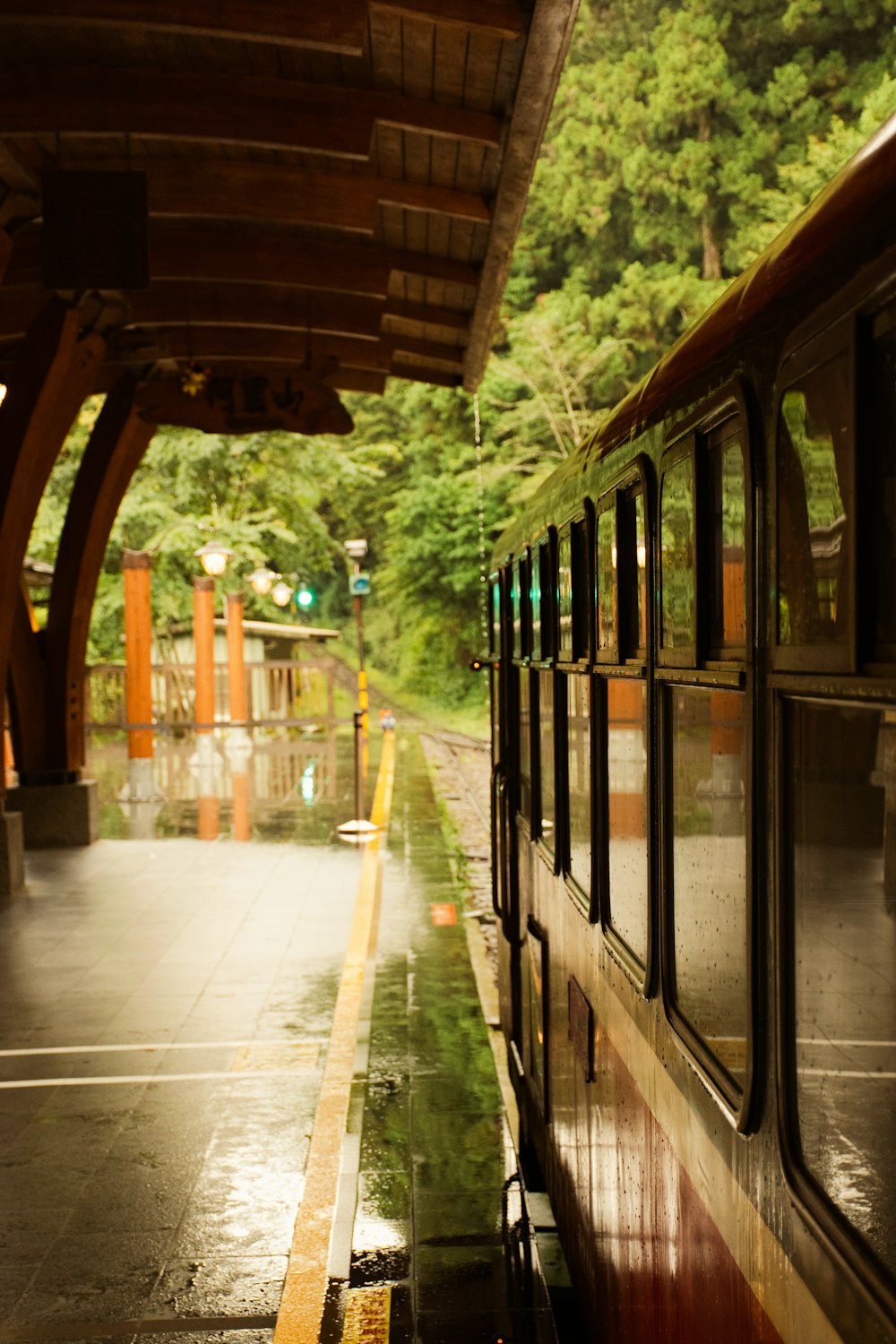 a train parked at a train station with trees in the background