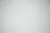 a black and white photo of a white wall