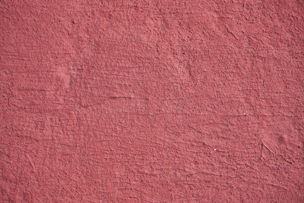 a close up of a wall with a red color