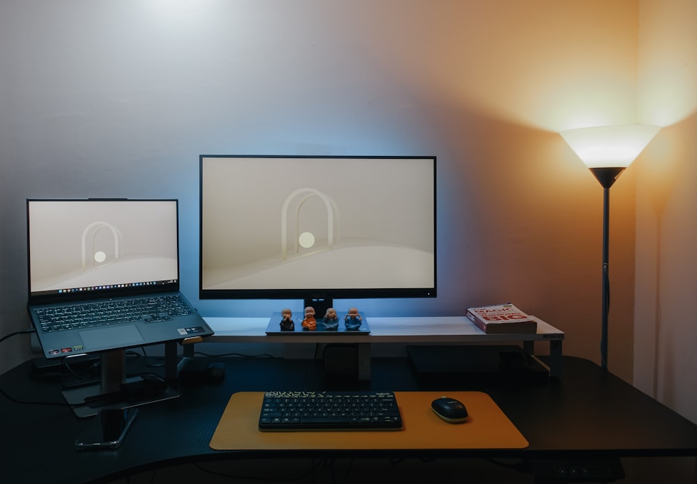 a desk with a laptop and a monitor on it