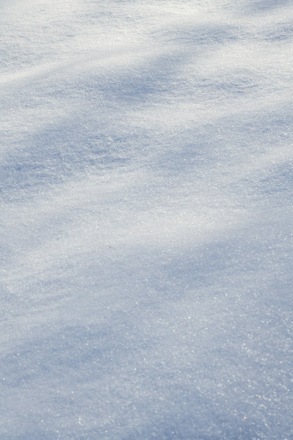 a snowboarder is going down a snowy hill