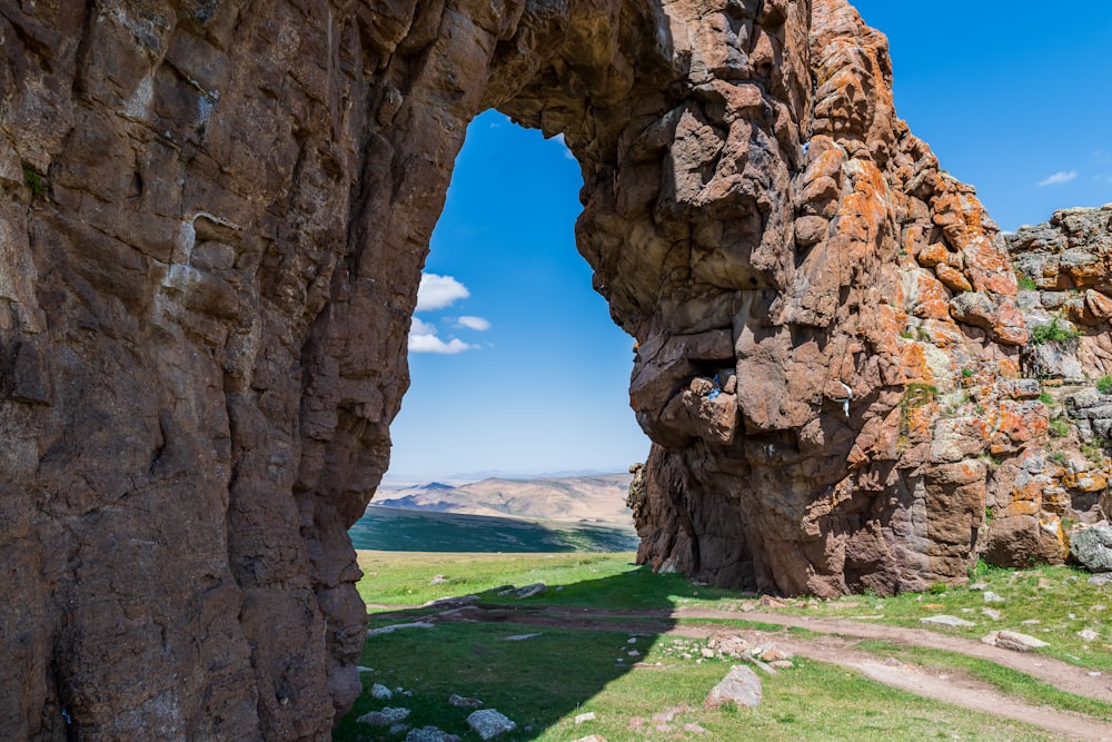 a large rock formation in the middle of a field