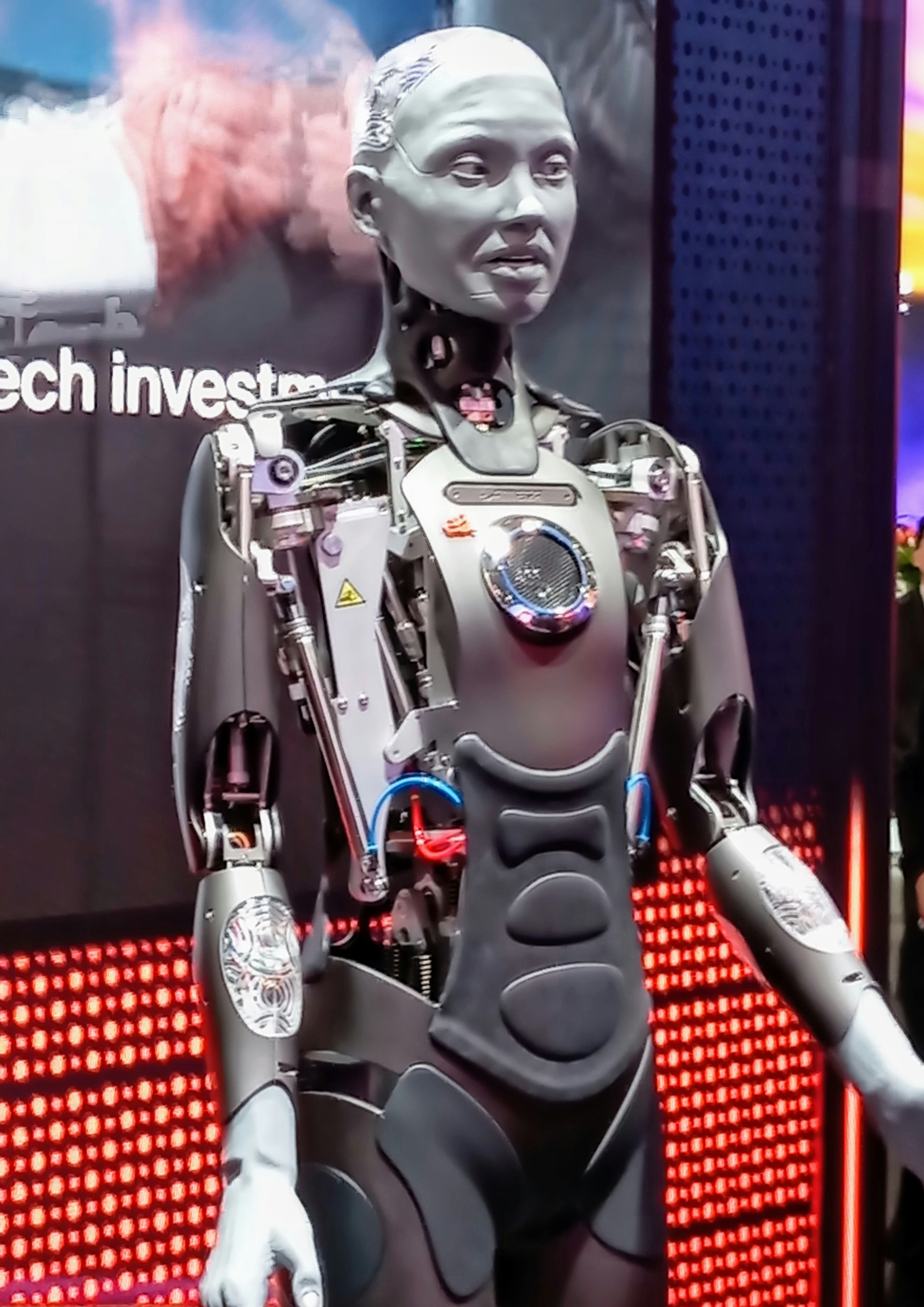 Branimo robot standing in front of a sign, representing innovative technology solutions.
