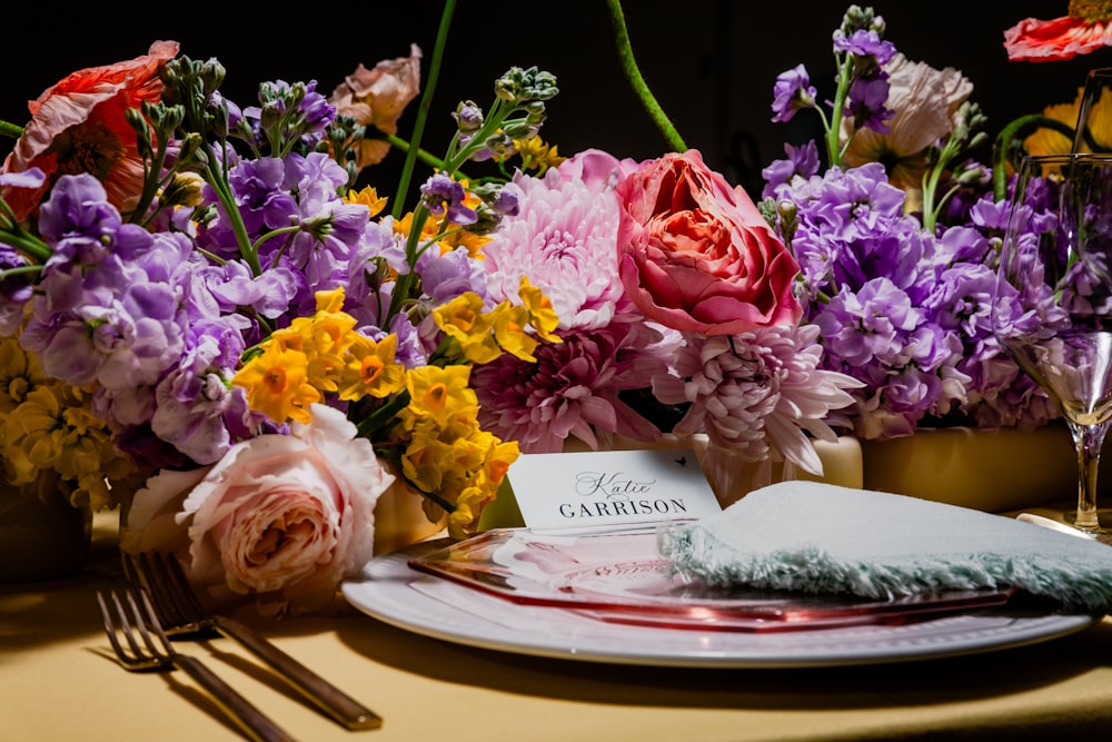 a table topped with a plate covered in flowers