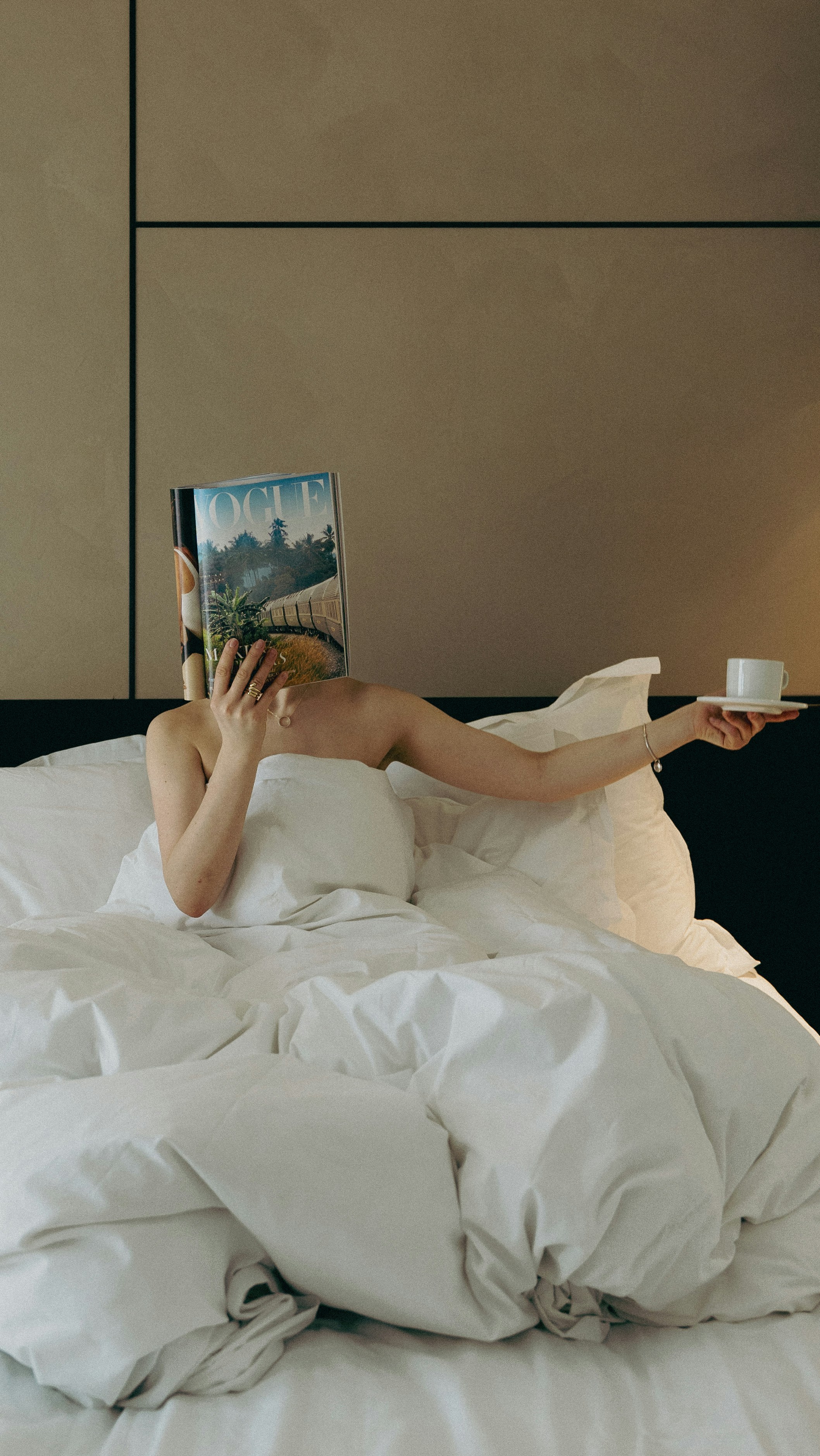 a woman laying in bed reading a book