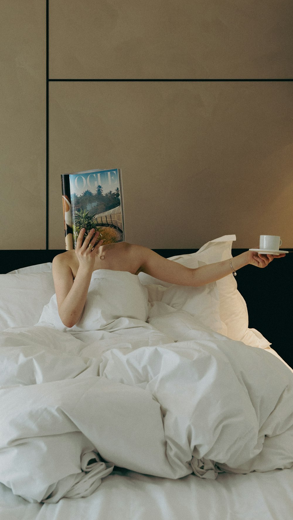 a woman laying in bed reading a book