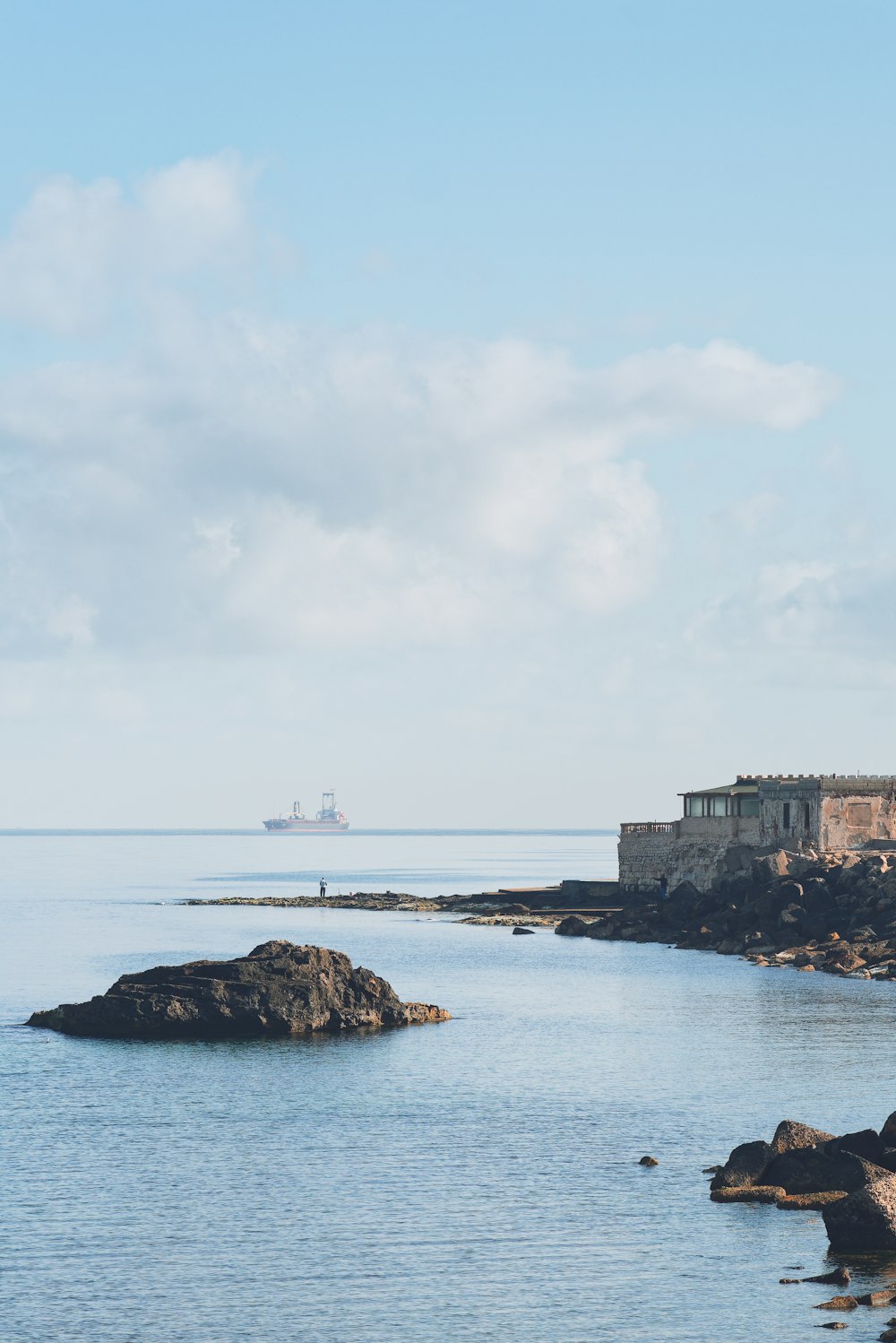 a large body of water with a castle in the background