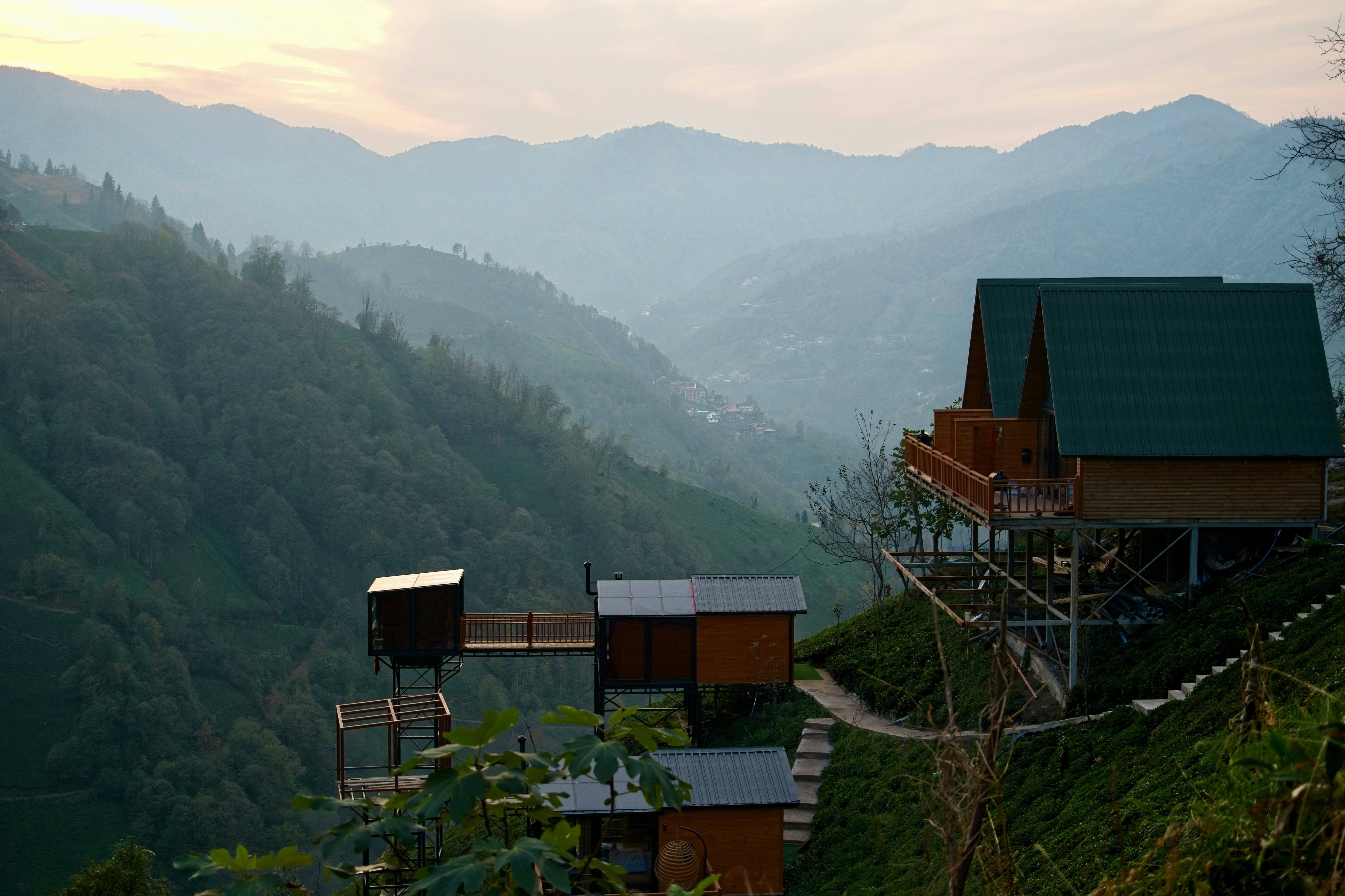 a house on a hill with mountains in the background