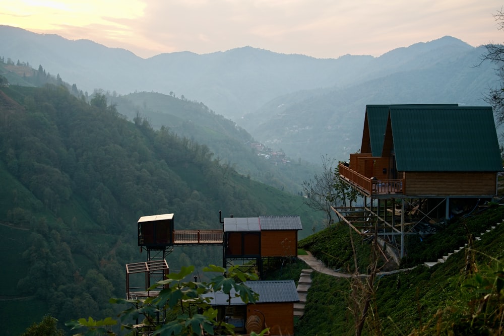 a house on a hill with mountains in the background