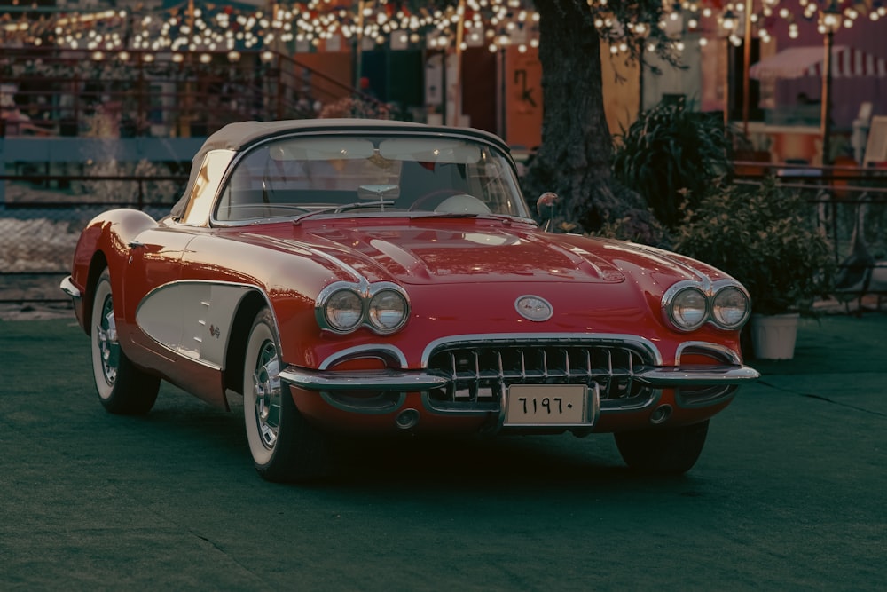 a red and white car parked in a parking lot