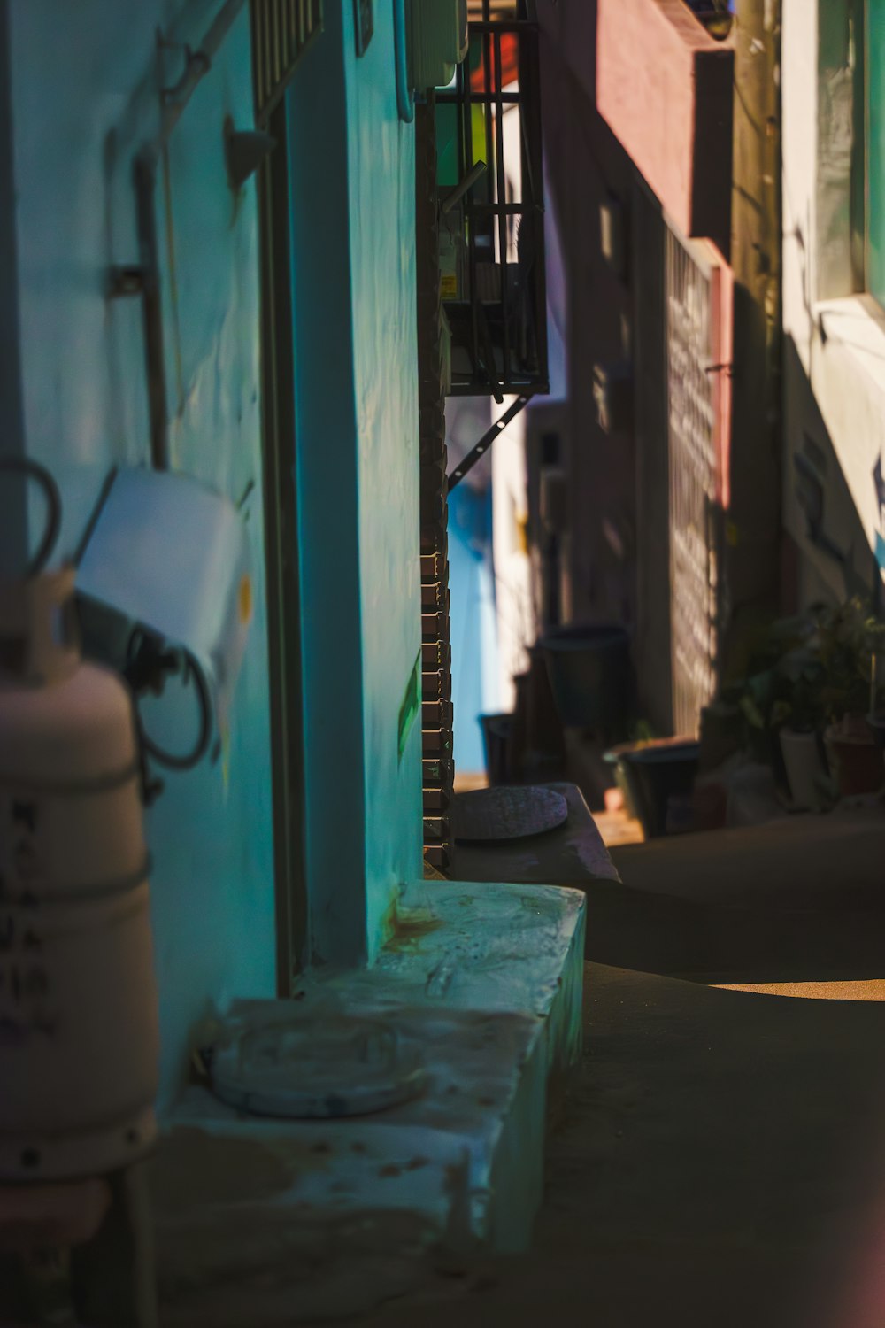 a narrow alleyway with a fire hydrant in the foreground