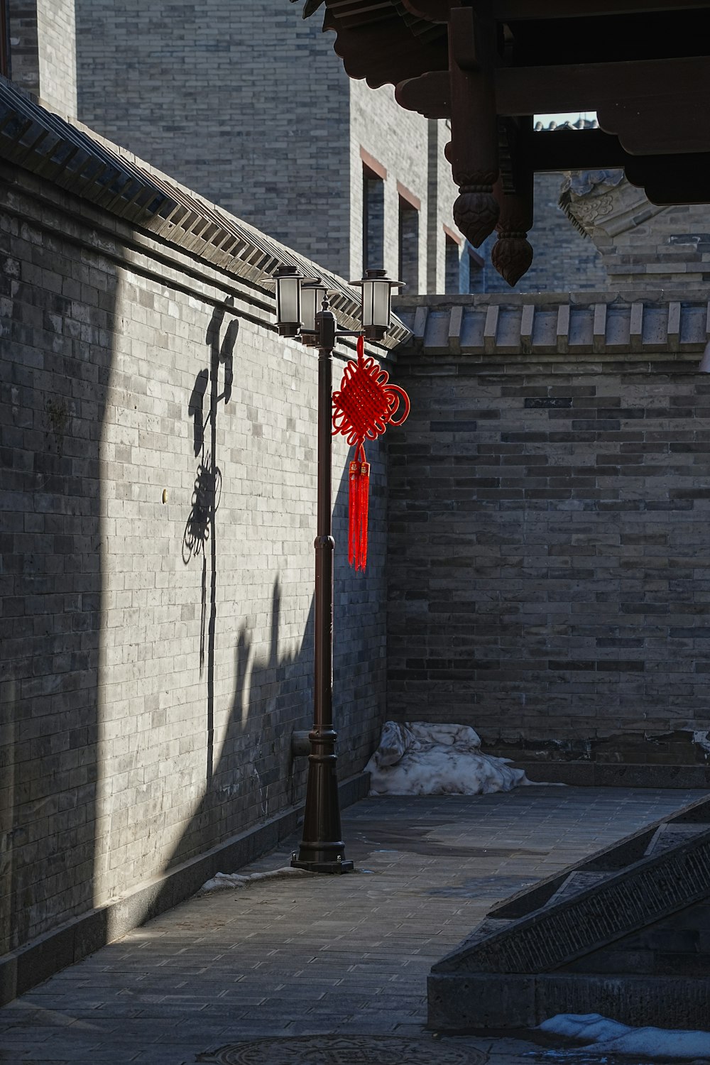 a street light with a red ribbon tied to it