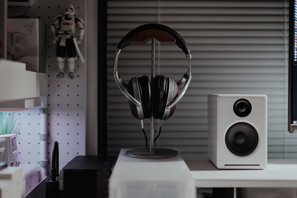 a desk with a computer and speakers on it