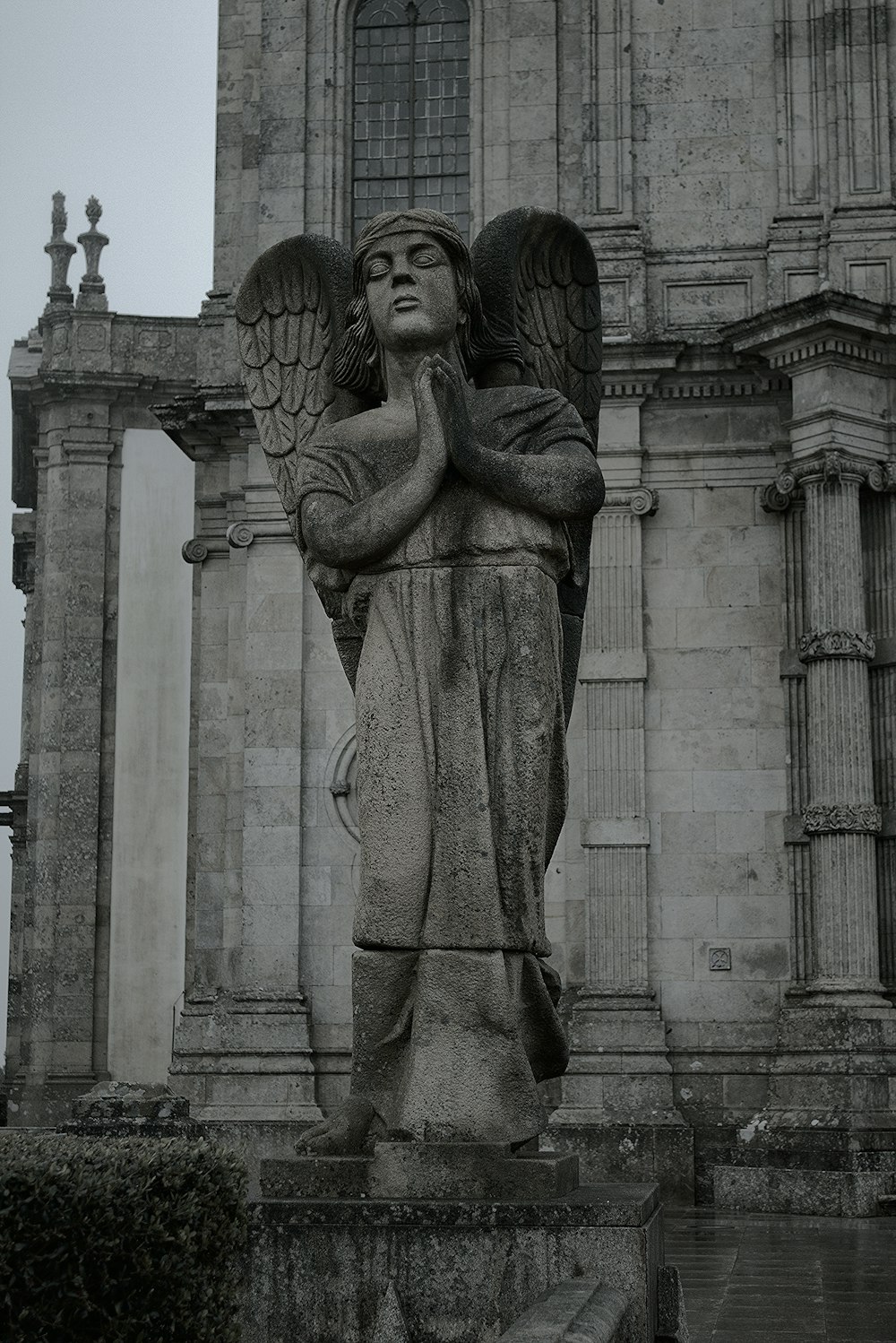 a black and white photo of a statue of an angel