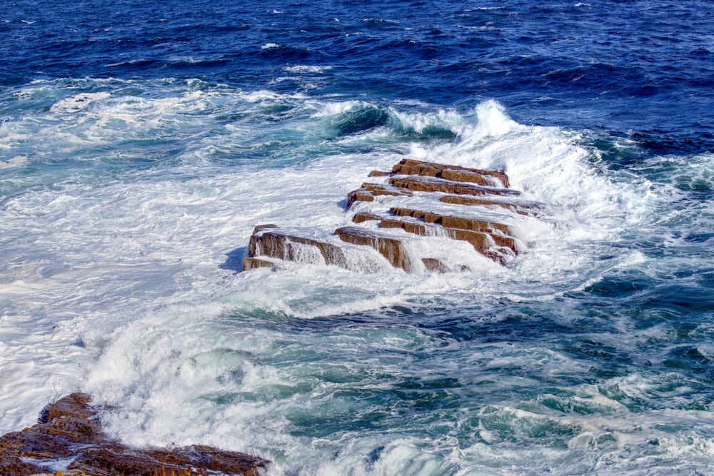 a large body of water next to a rocky shore