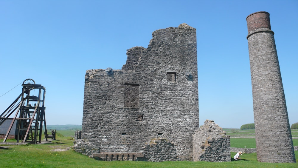 a tall tower sitting next to a tall brick building