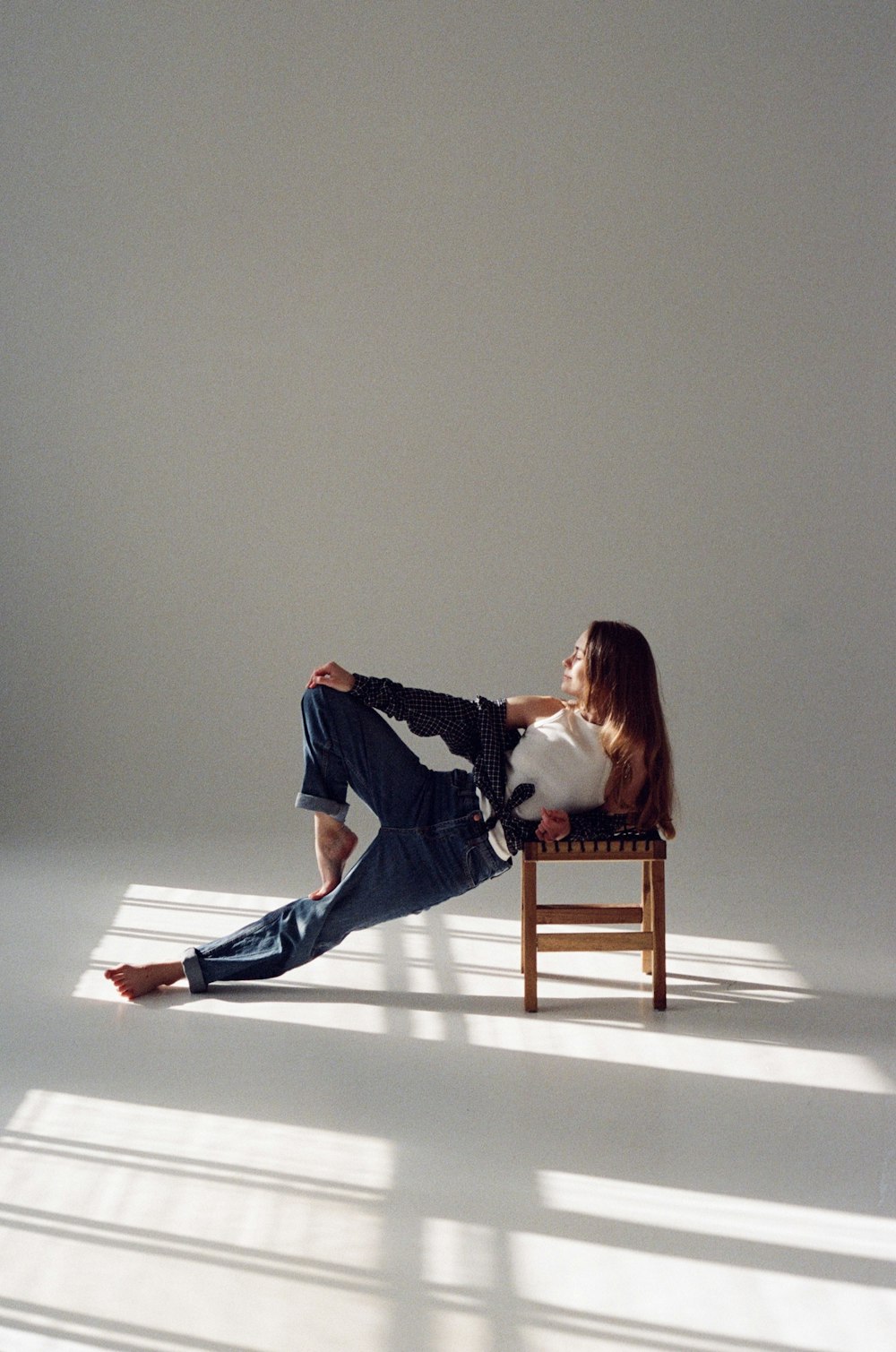 a woman sitting on a chair with a cat in her lap