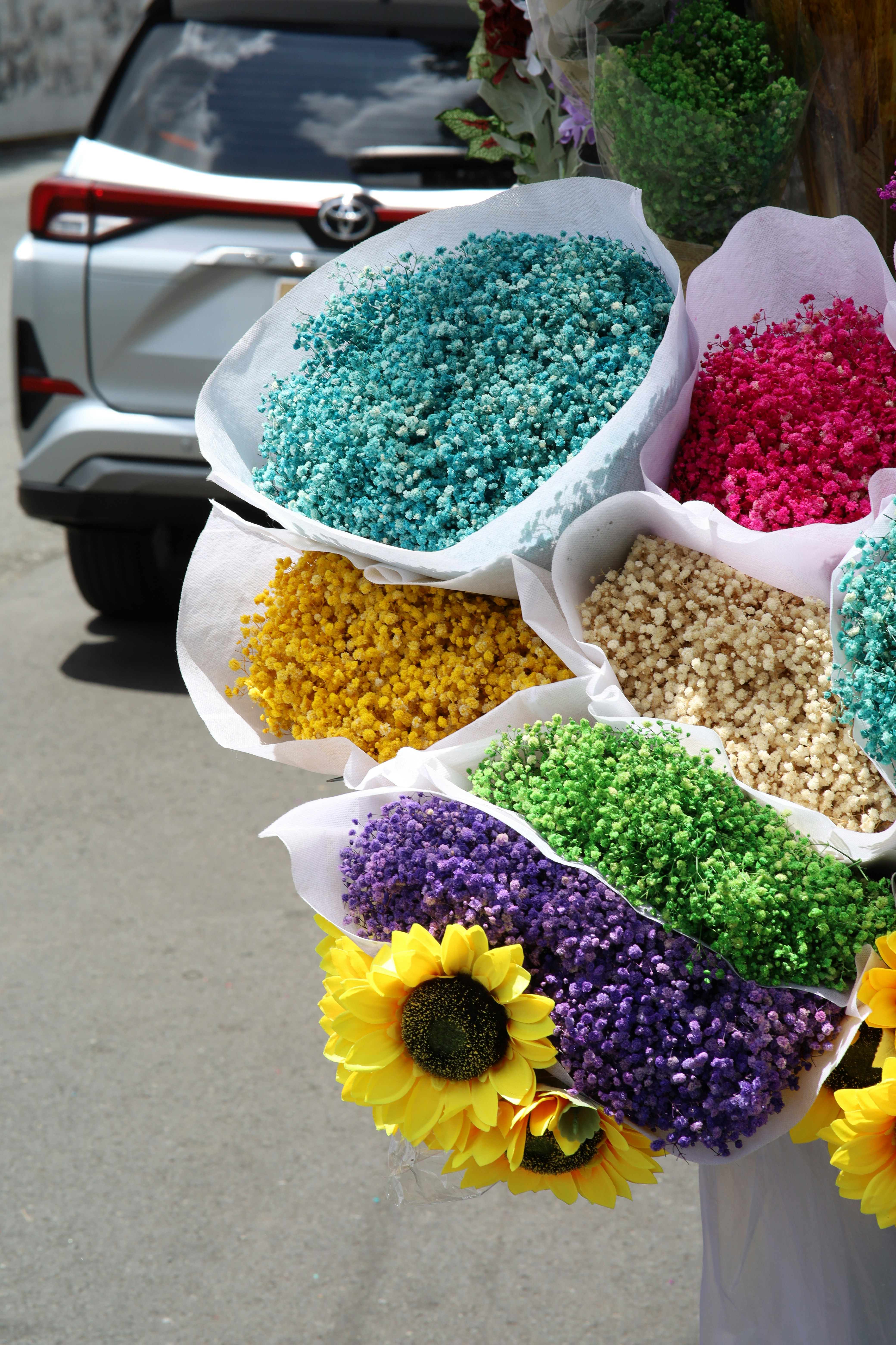 a bunch of flowers that are in some bags