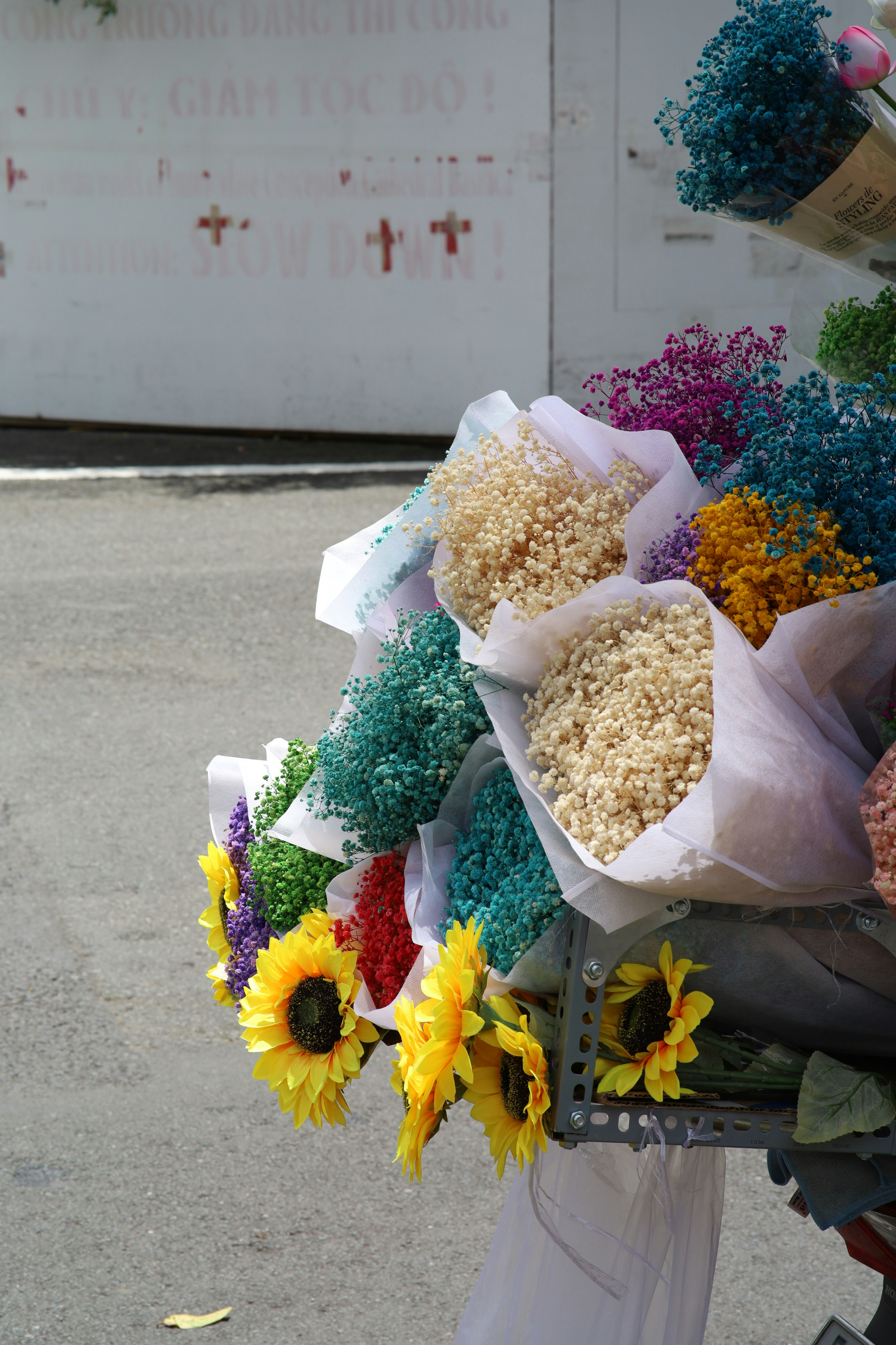 a bunch of flowers that are sitting on a cart