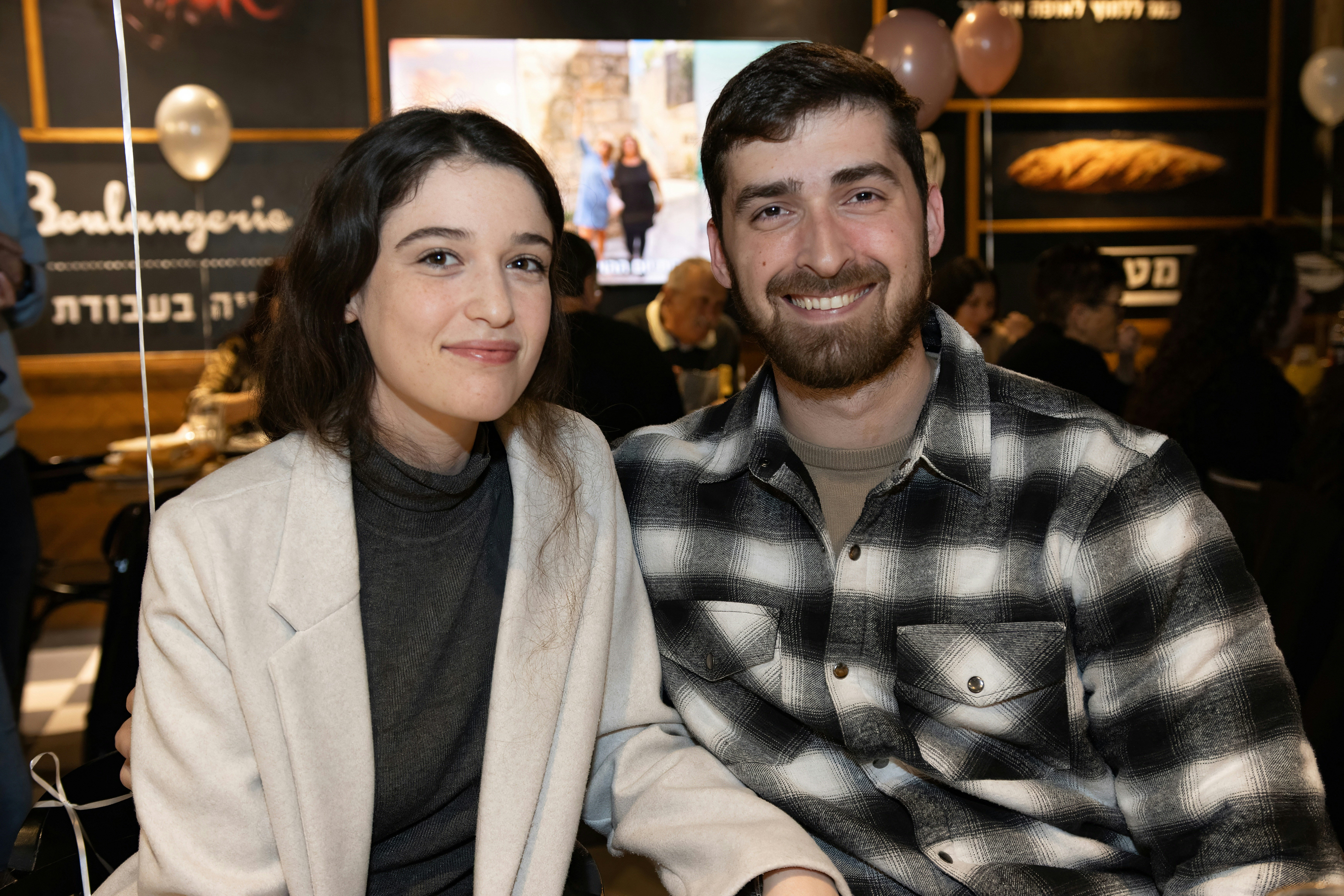 a man and a woman sitting next to each other