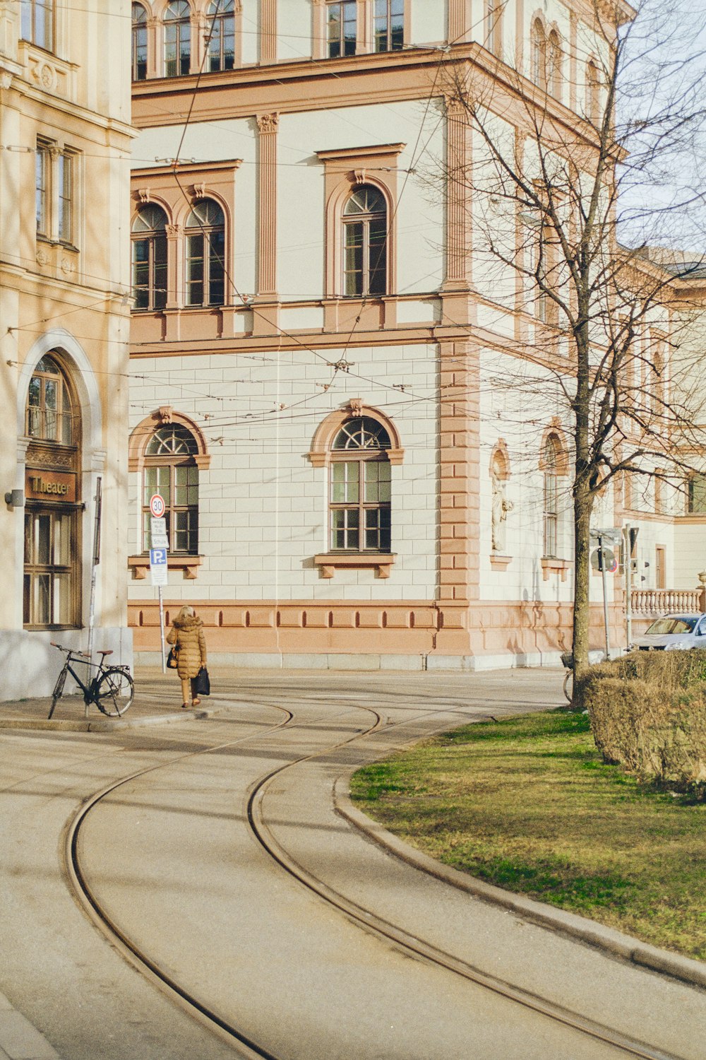 a person sitting on a bench in front of a building