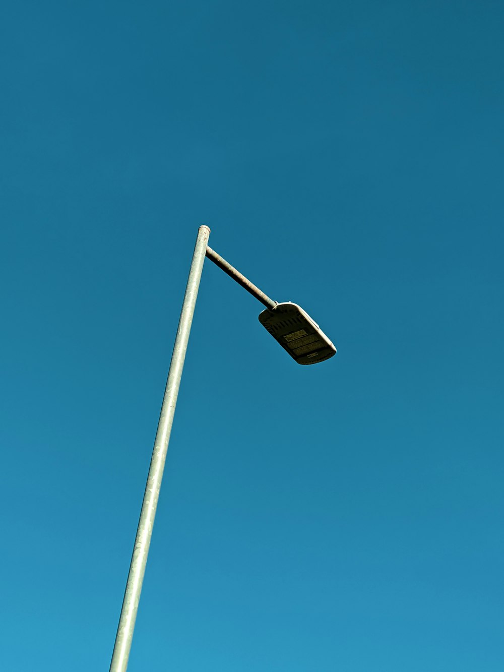 a street light with a blue sky in the background