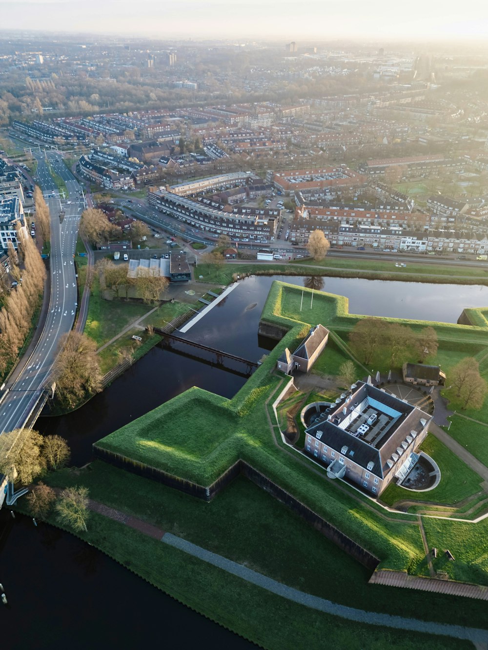 an aerial view of a large building with a green roof