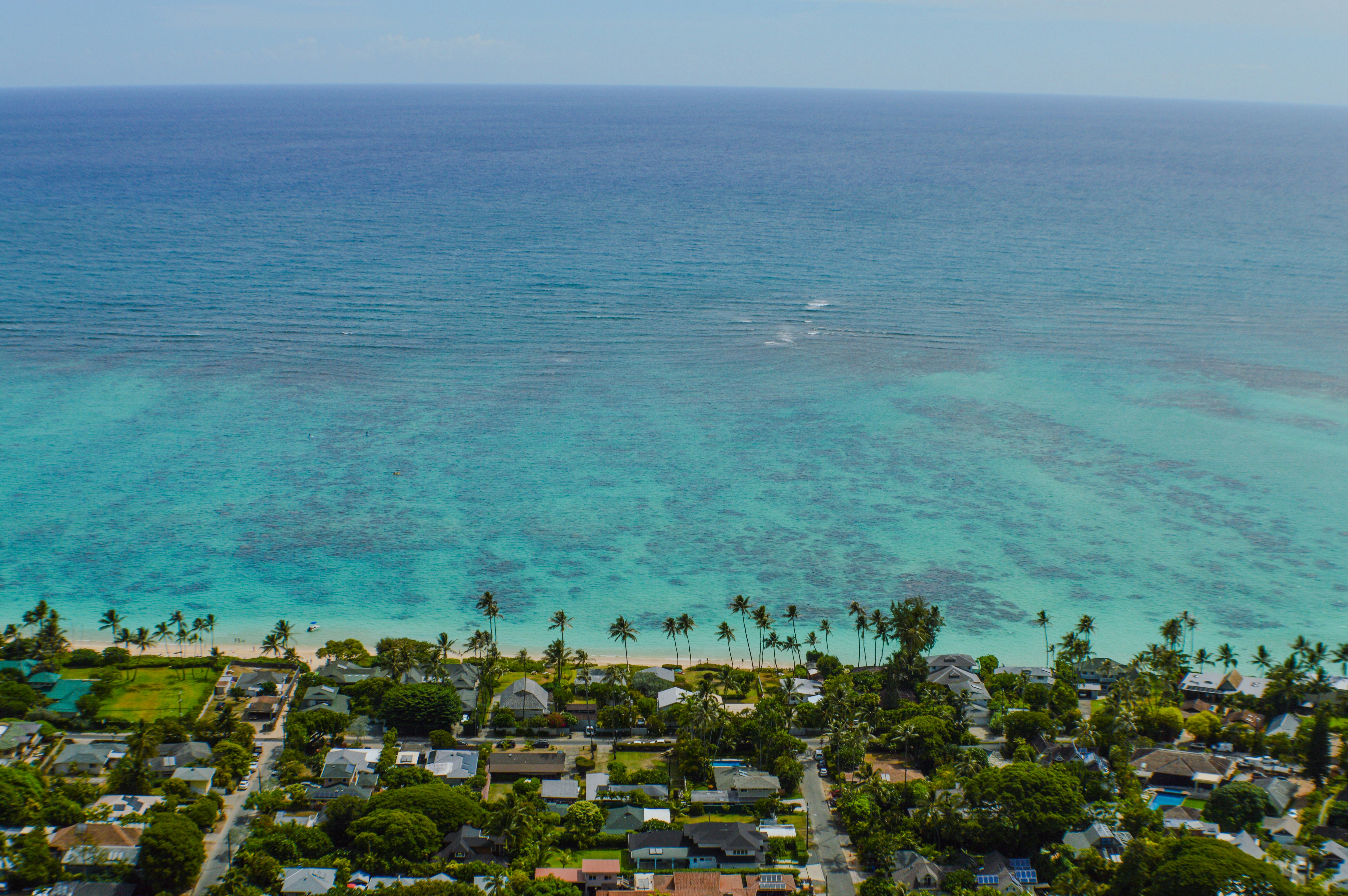 an aerial view of a tropical island with a boat in the water, View from the Lanikai Pillbox Trail, O