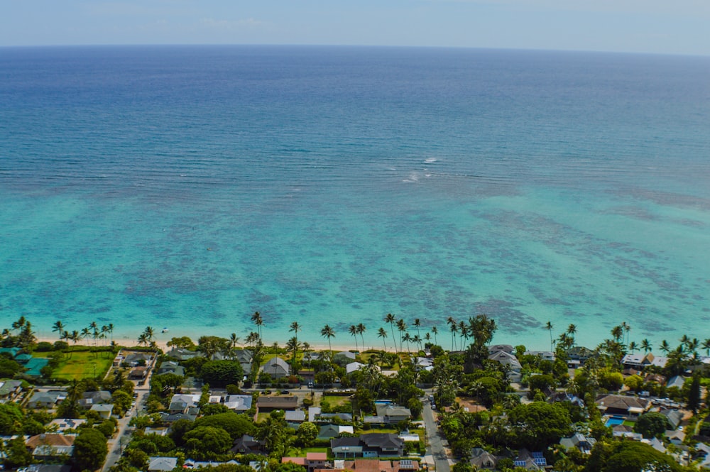 an aerial view of a tropical island with a boat in the water