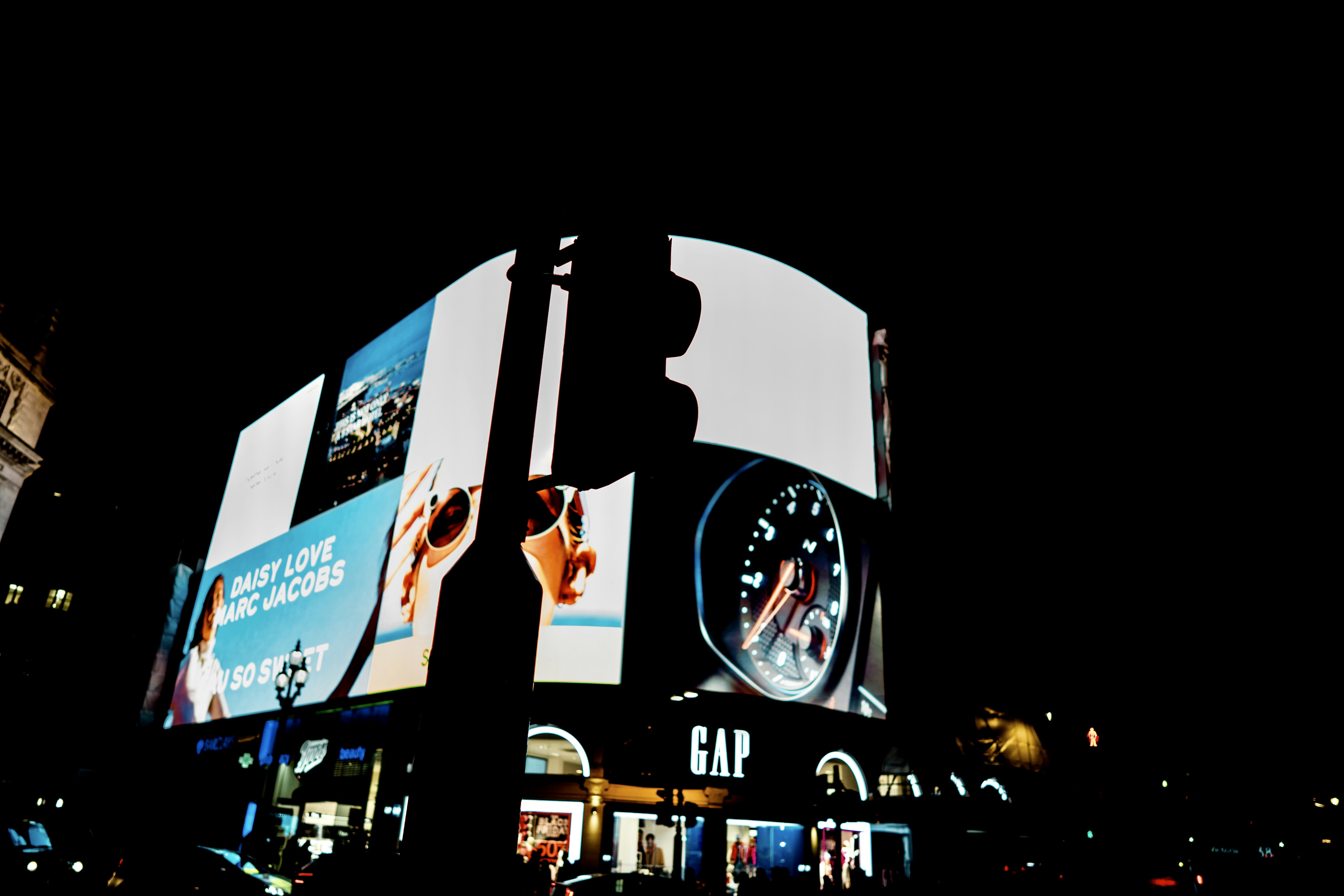 Digital billboard displaying programmatic advertising content in urban Accra Ghana night scene