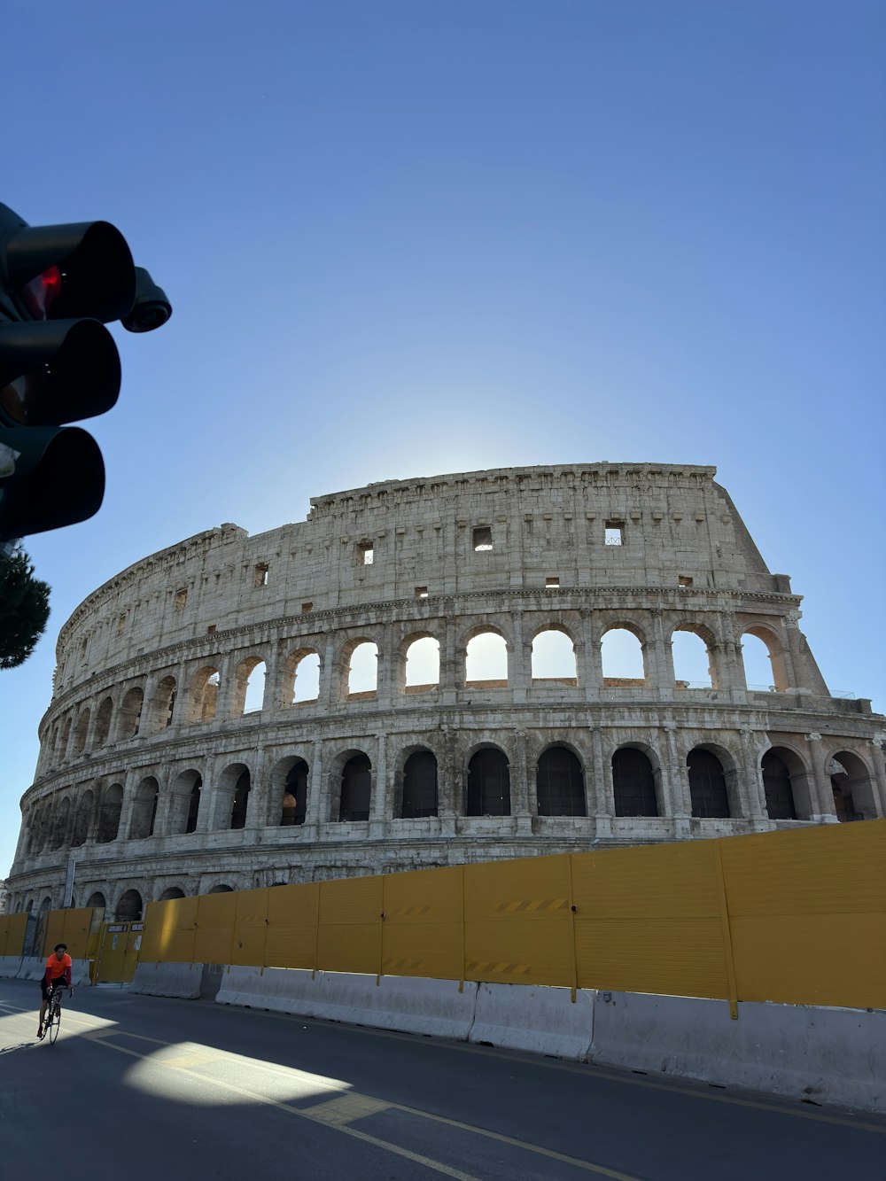 un uomo in sella a una bicicletta davanti a un edificio molto alto