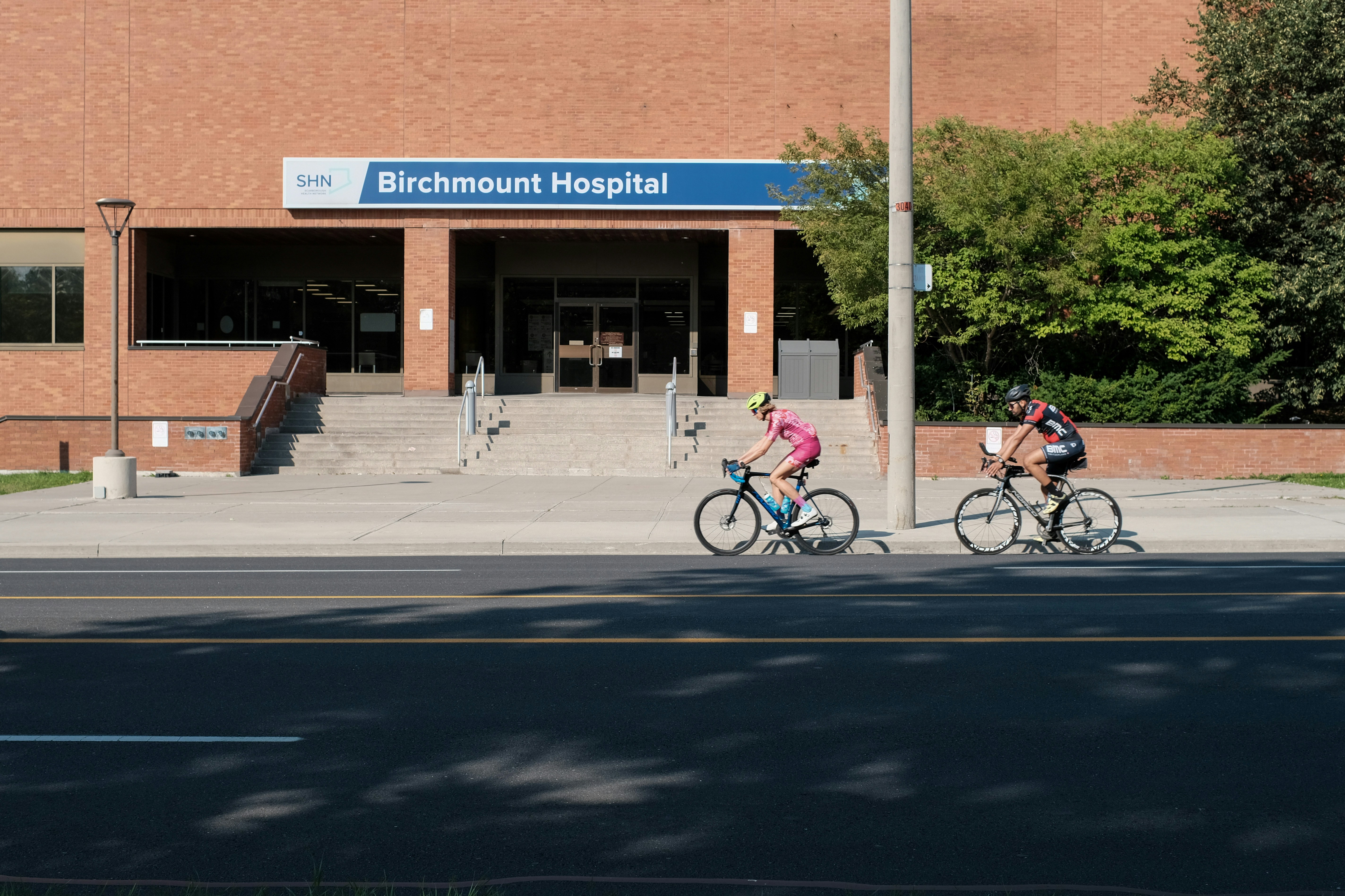 a couple of people riding bikes down a street
