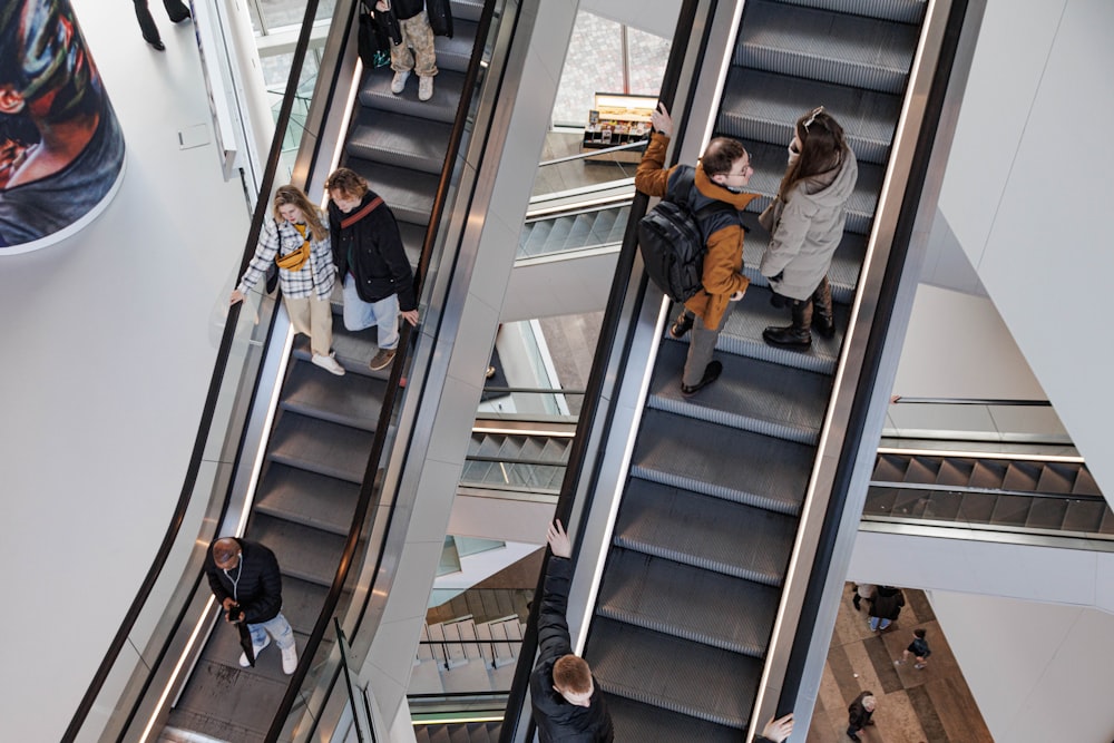 a group of people riding down an escalator