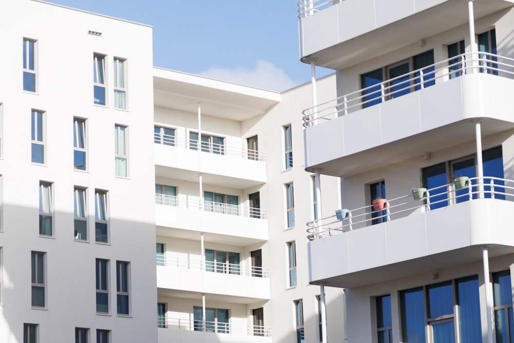 a white building with balconies and balconies on the balconies