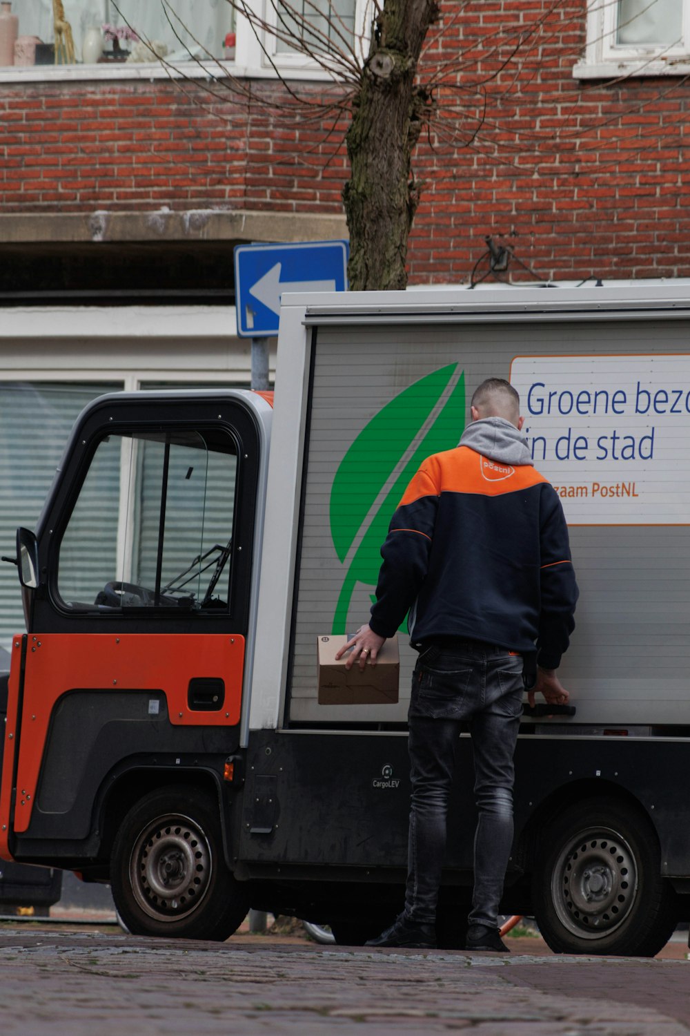 a man standing next to a delivery truck