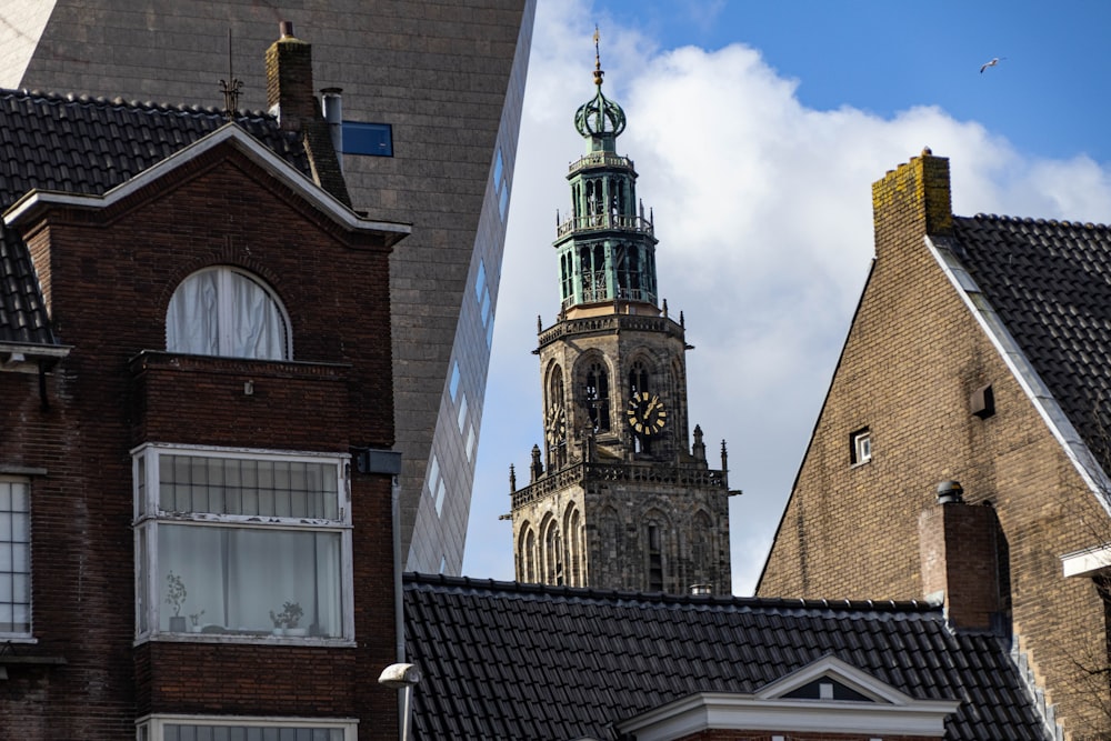 a tall building with a clock tower next to other buildings