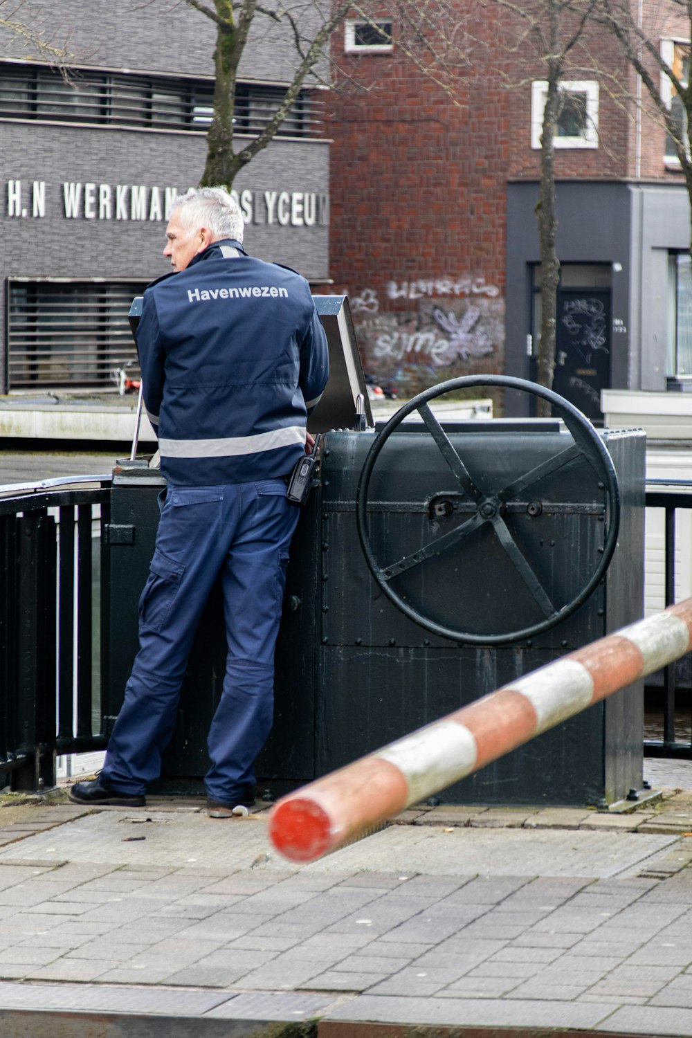 a man standing next to a machine on a sidewalk