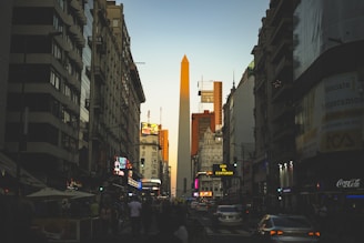 a tall obelisk towering over a city filled with tall buildings
