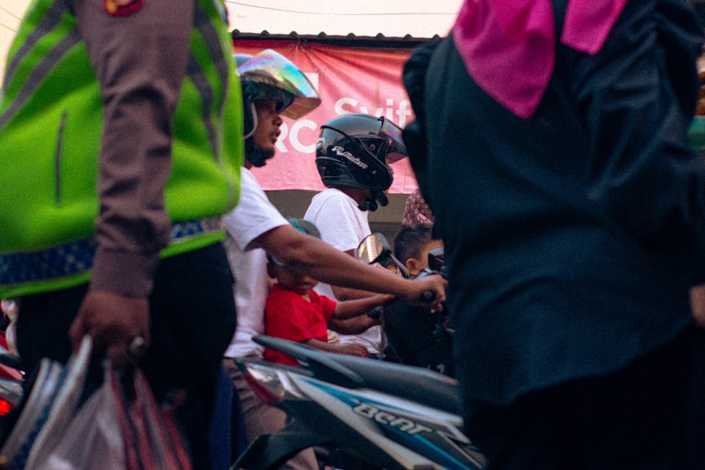 a group of people standing around a motorcycle