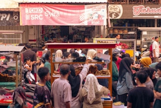 a crowd of people standing around a market