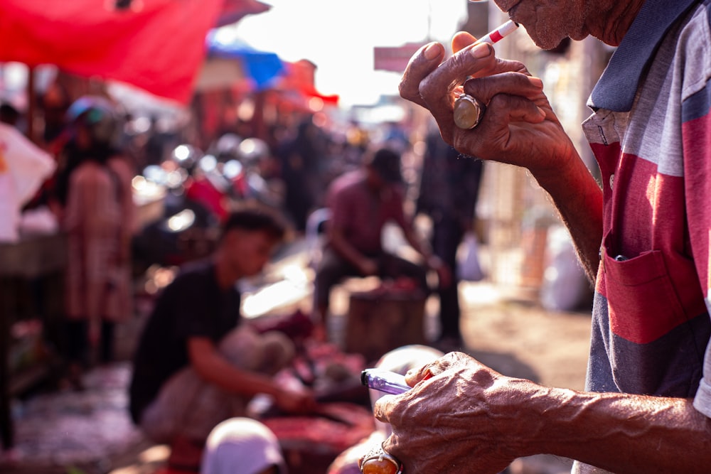 an old man holding a cell phone in his hand