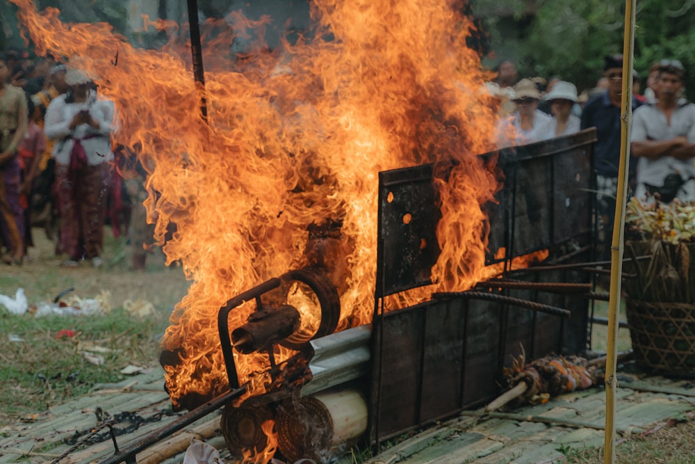 a group of people standing around a fire pit