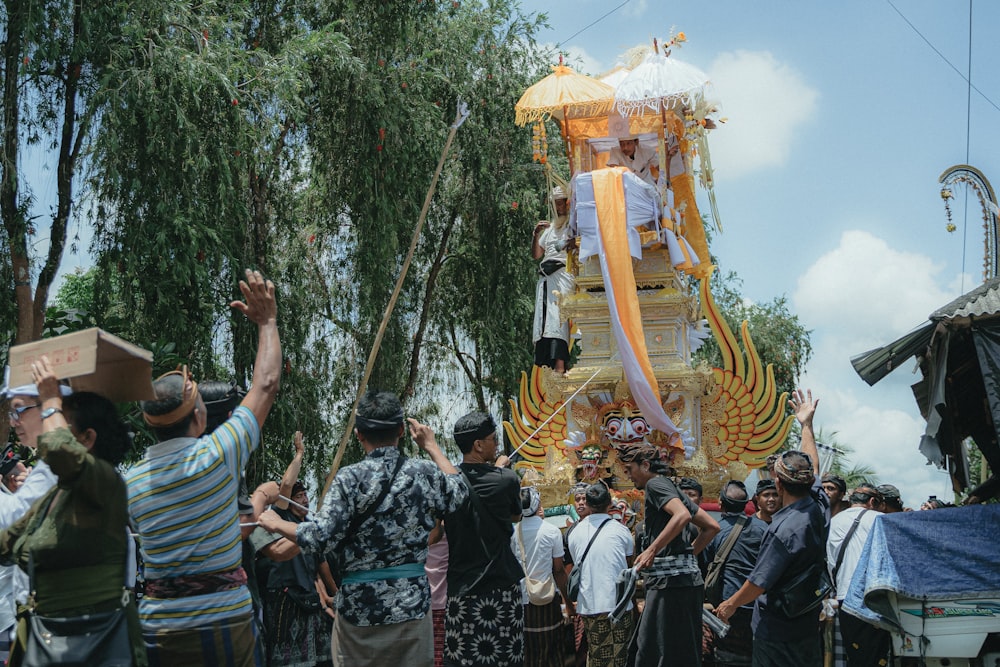 a group of people standing around a float