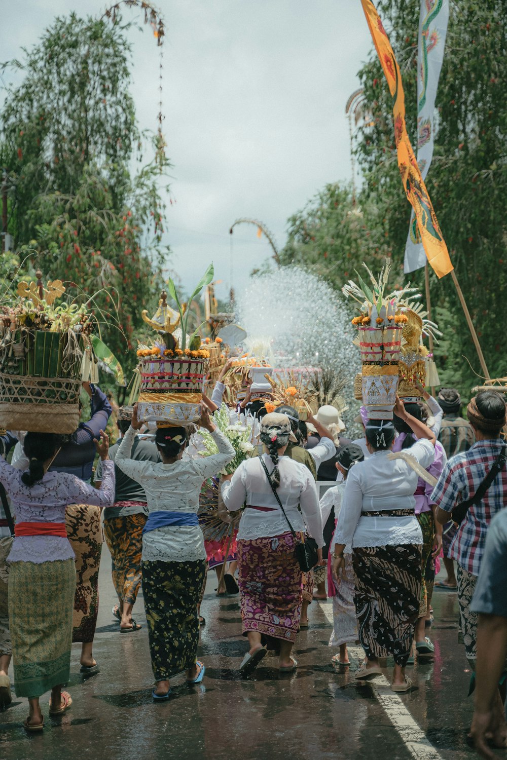 a group of people walking down a street with baskets on their heads