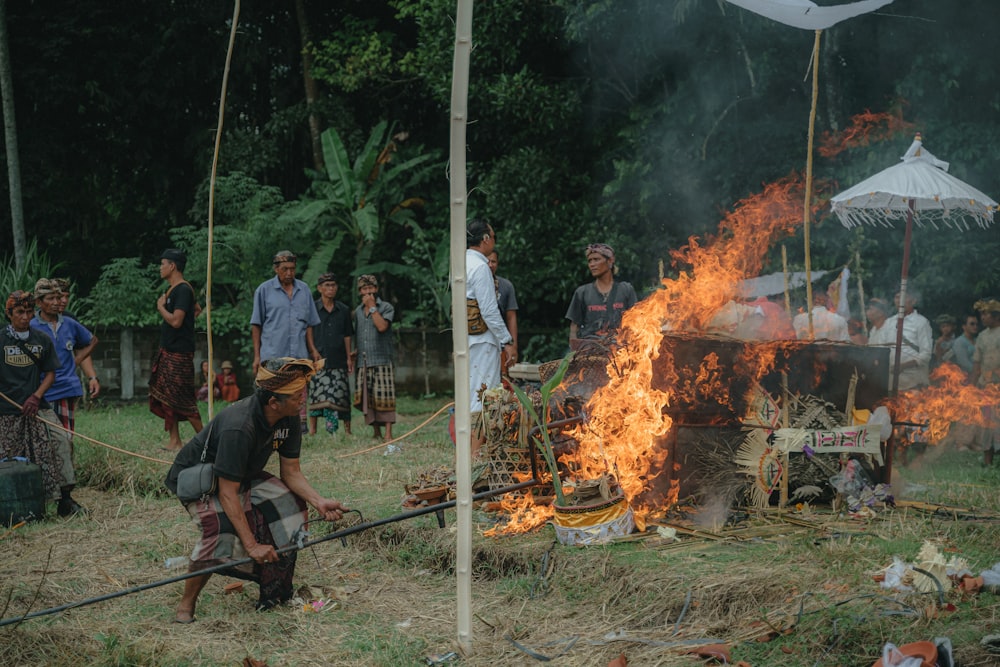 a group of people standing around a fire