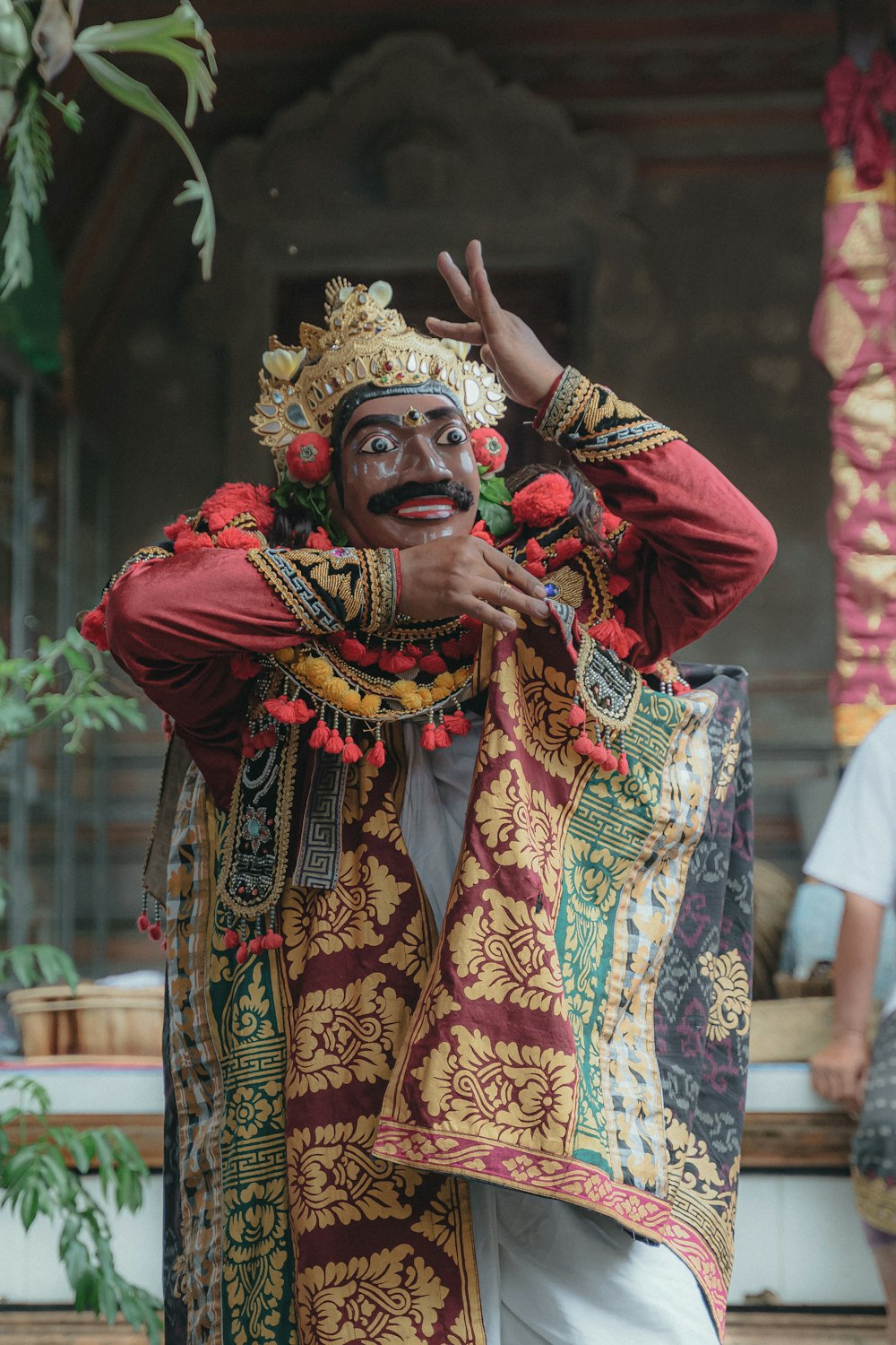 a man dressed in a costume and holding his hands up