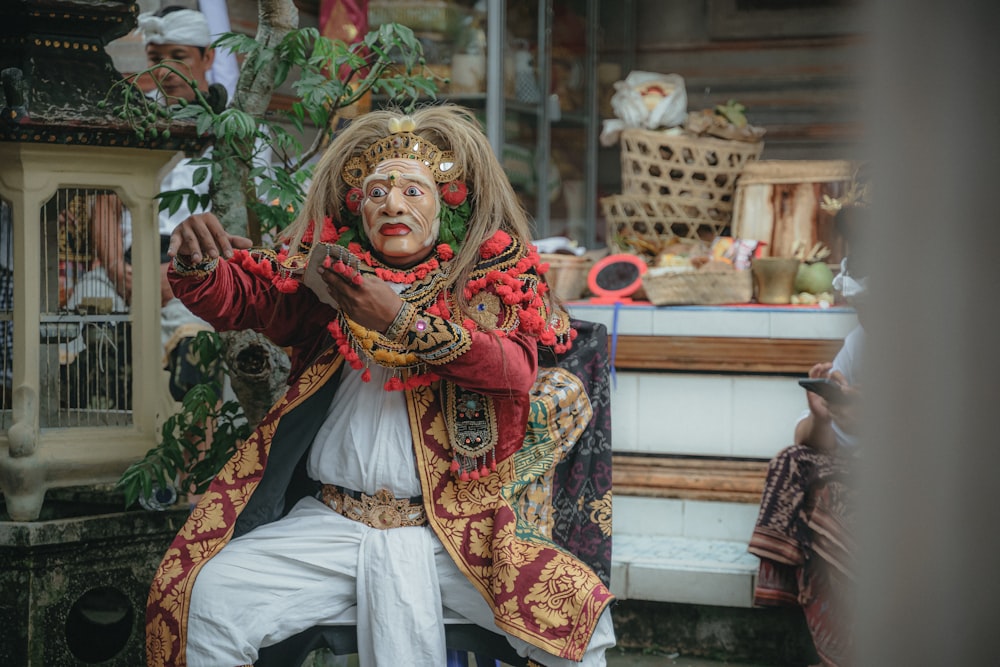 a man dressed in a costume with a snake around his neck