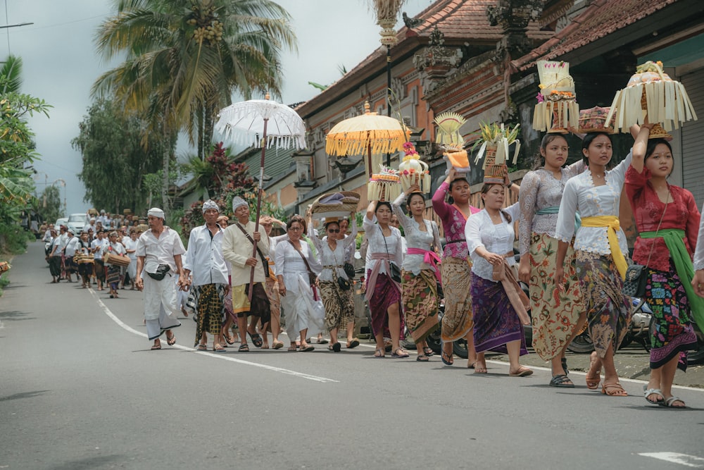 a group of people walking down a street holding umbrellas