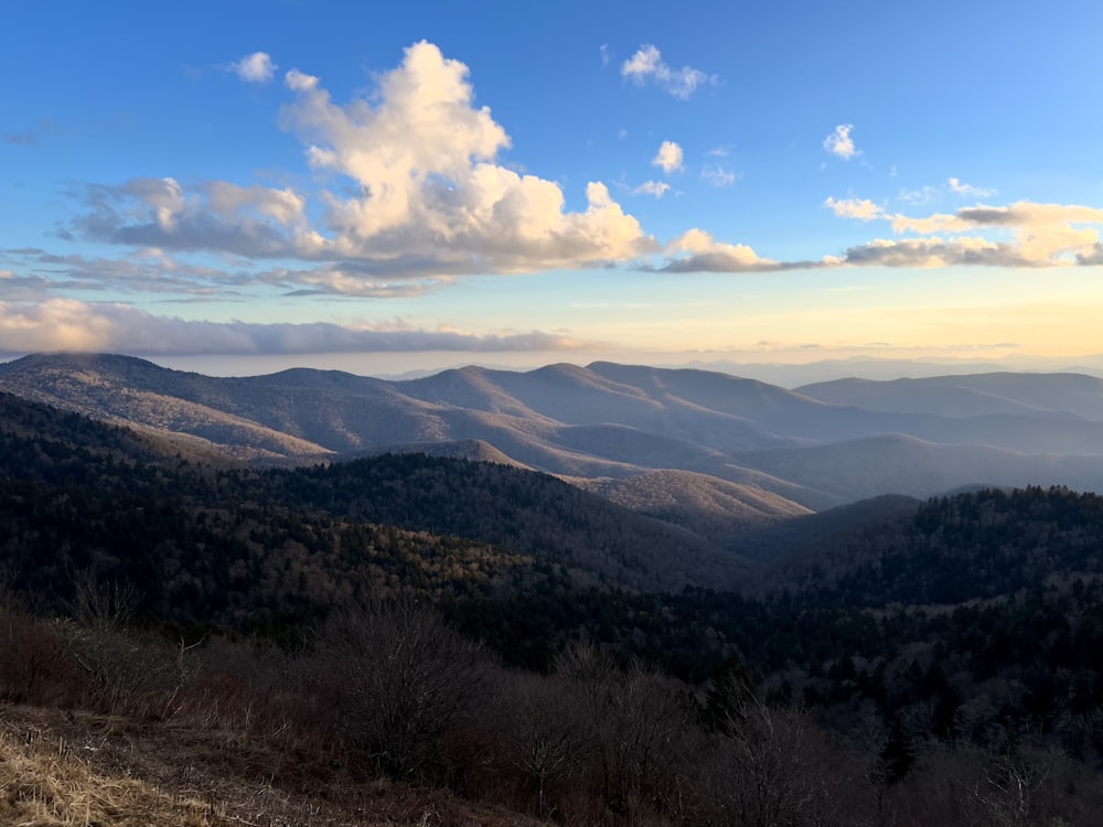 a view of a mountain range with clouds in the sky